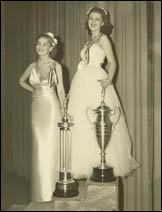 Proudly displaying their trophies, Marilyn Meseke (left), Miss America 1938, and Claire James (right), Miss California and 1st runner-up pose for the camera. Marilyn  won 'Most Perfect Model,' and Claire received the honor of 'Most Beautiful Girl in an Evening Gown.'